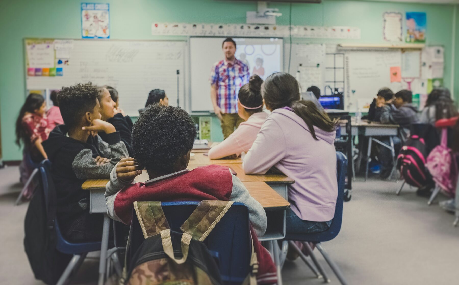 Tutor teaching students in a classroom