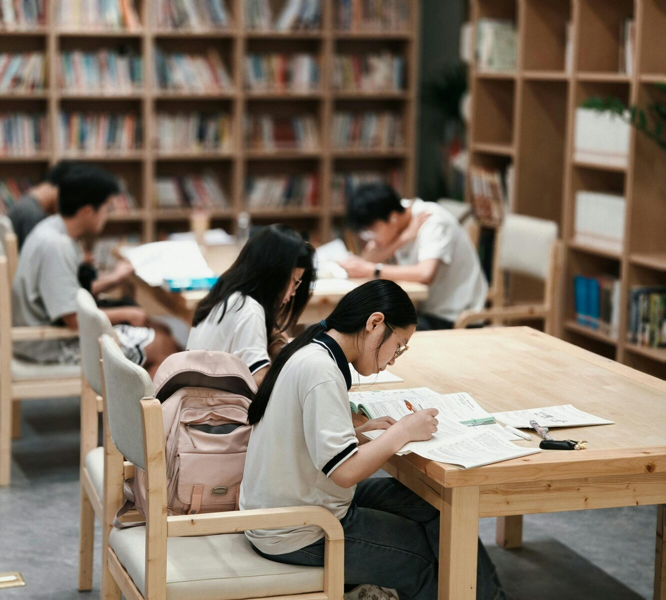 Students studying English materials in a library